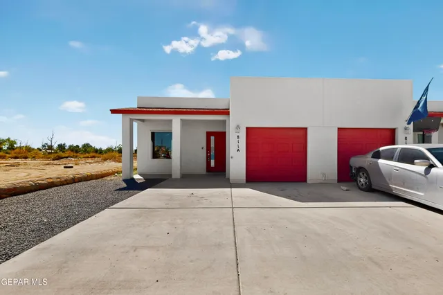 a front view of a house with parking space