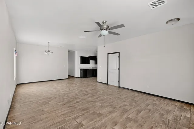 a kitchen with stainless steel appliances granite countertop a refrigerator stove and sink