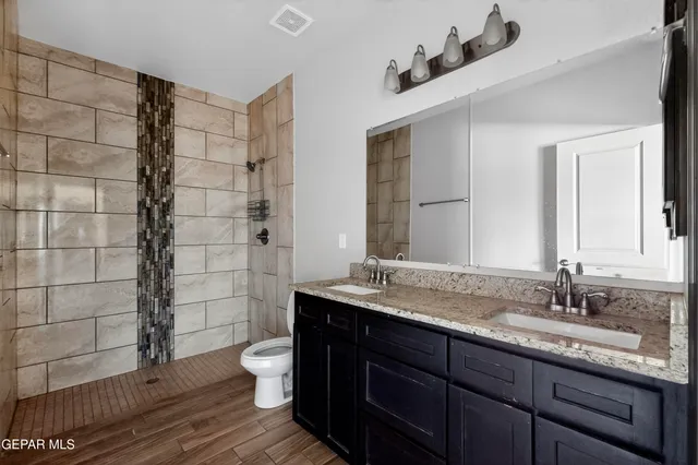 a bathroom with a toilet sink and mirror