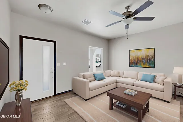 a living room with furniture and wooden floor