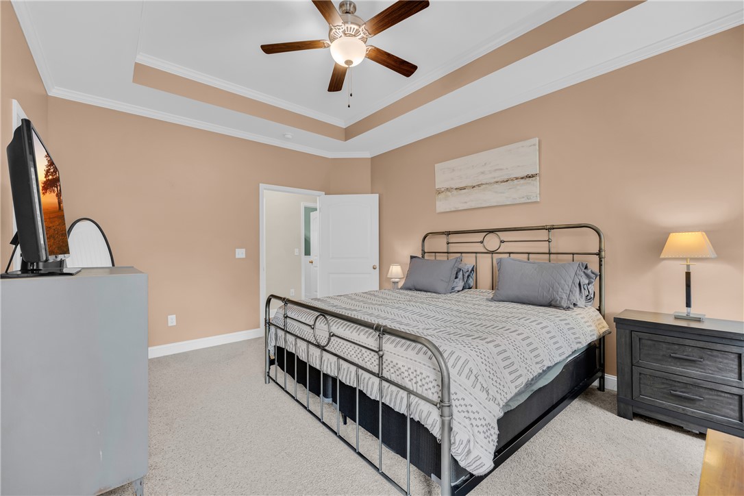 5 Drakeford Court Anderson, SC 29621 - Photo 31 of 46 A tray ceiling with crown molding elevates this comfortable bedroom featuring wall-to-wall carpeting.