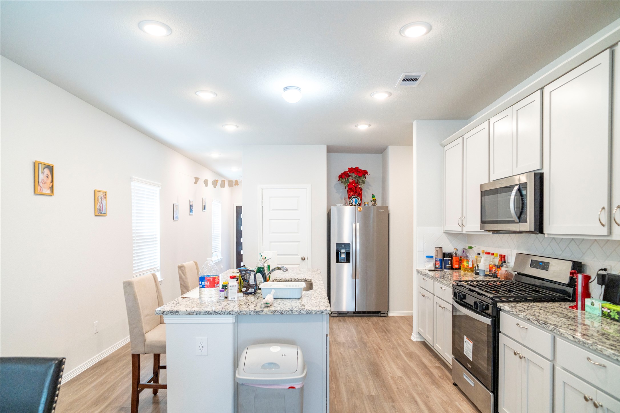 23319 Spring Genesis Lane Katy, TX 77493 - Photo 5 of 22 a kitchen with granite countertop a sink appliances and cabinets