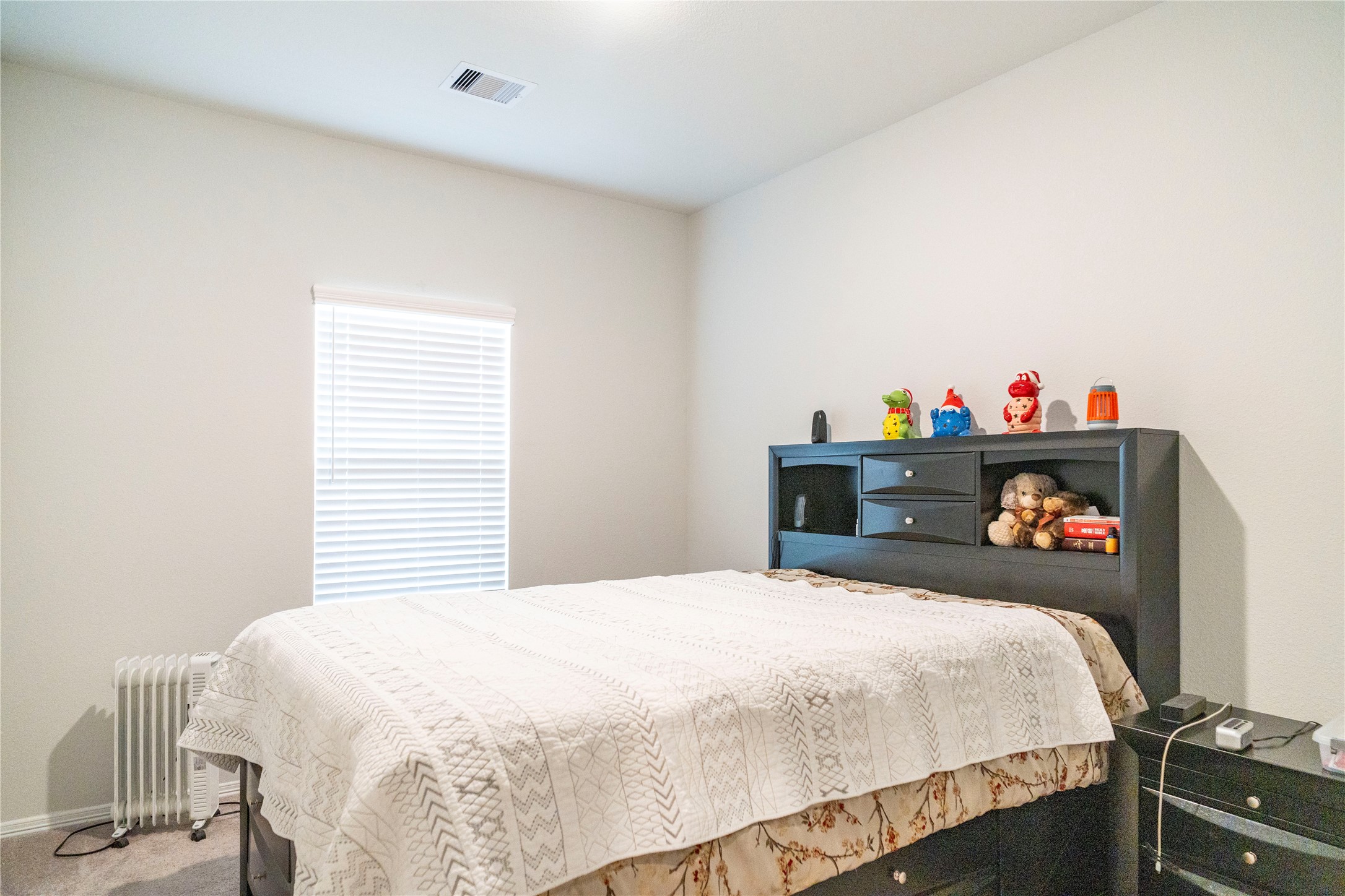23319 Spring Genesis Lane Katy, TX 77493 - Photo 6 of 22 a bedroom with a bed and a dresser