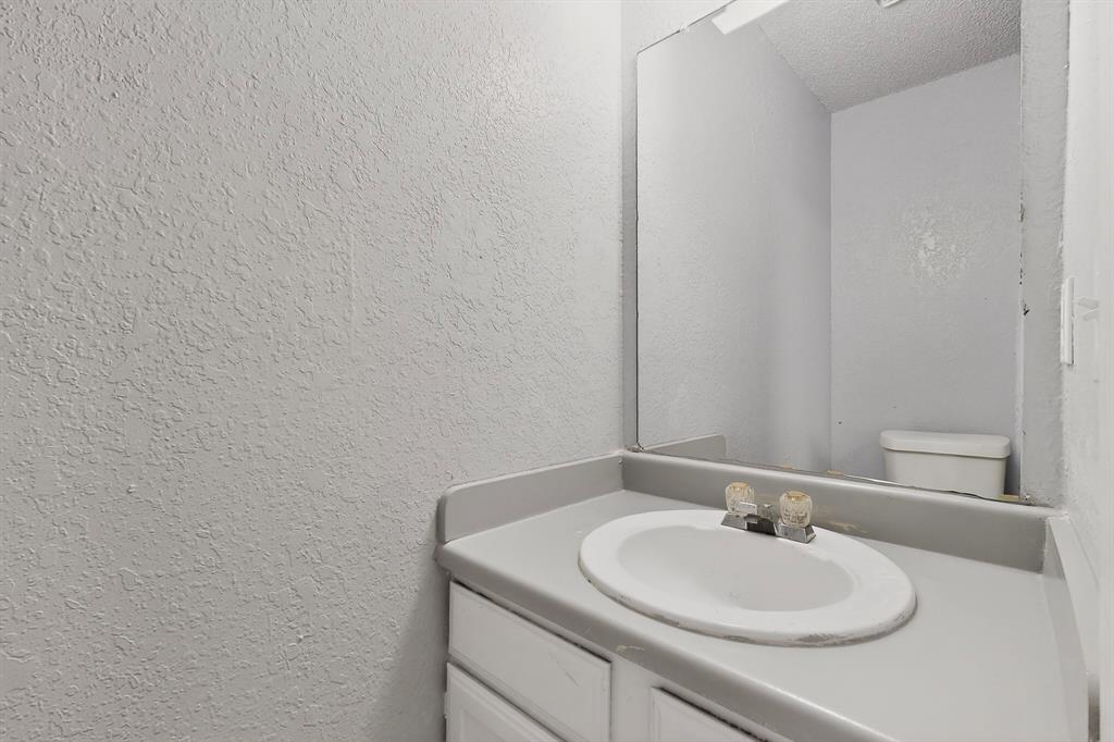 9467 Olde Towne Row Dallas, TX 75227 - Photo 12 of 26 a bathroom with a sink and a mirror