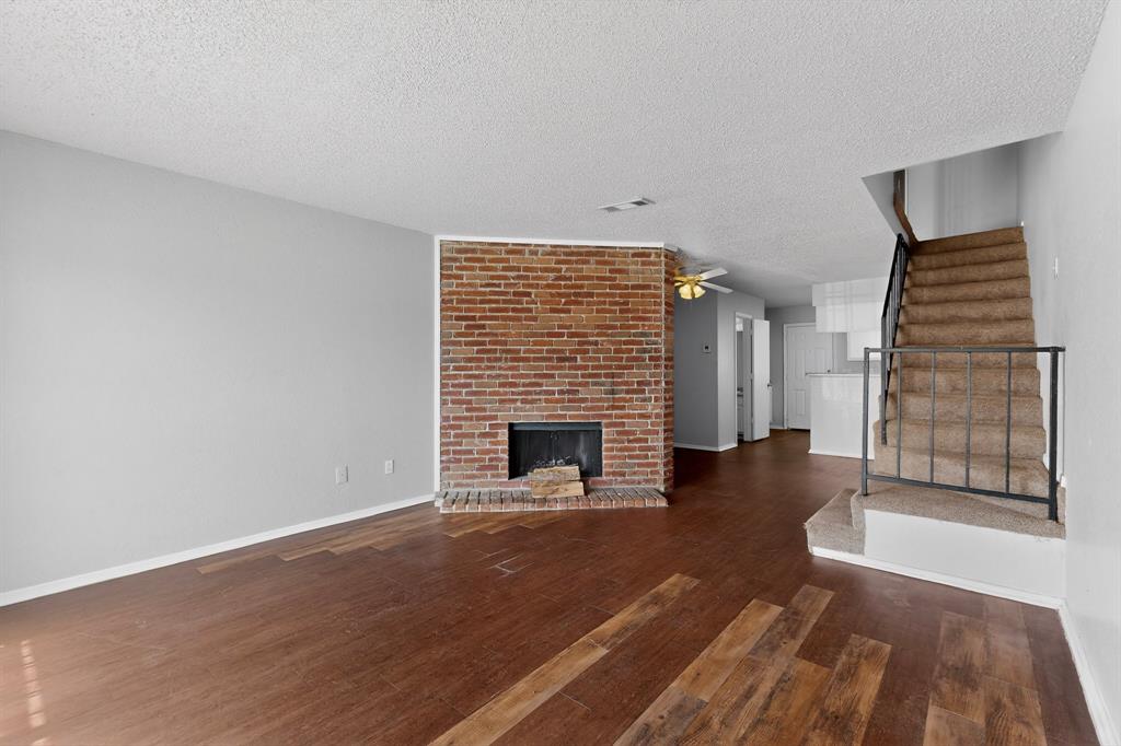 9467 Olde Towne Row Dallas, TX 75227 - Photo 2 of 26 a view of a livingroom with a fireplace and window