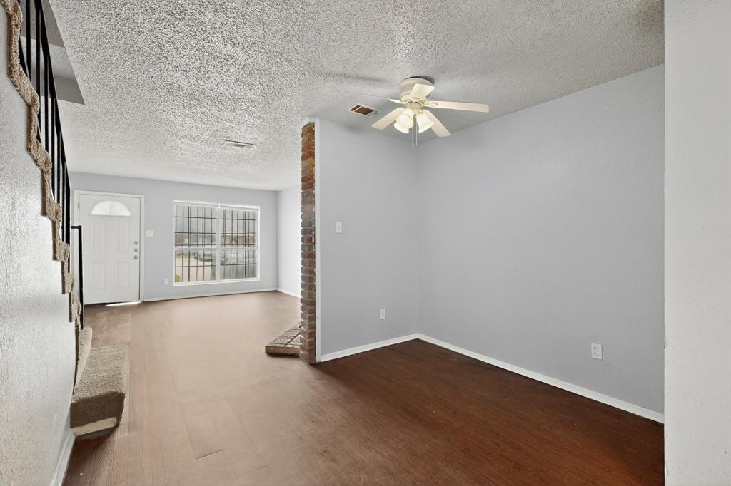 9467 Olde Towne Row Dallas, TX 75227 - Photo 4 of 26 an empty room with wooden floor and windows