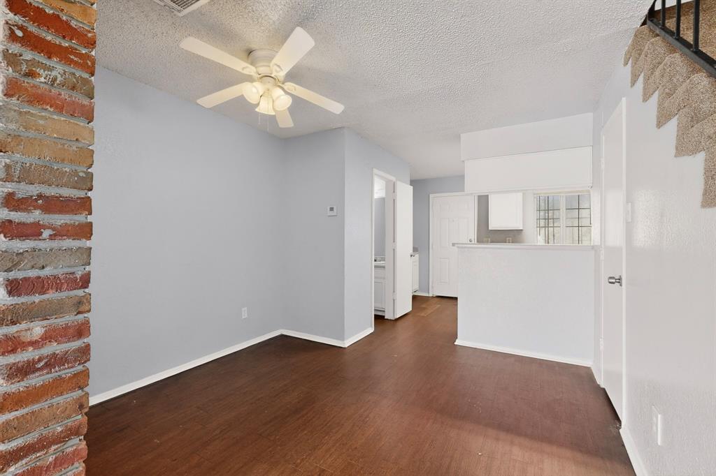 9467 Olde Towne Row Dallas, TX 75227 - Photo 6 of 26 a view of an empty room with wooden floor and a ceiling fan