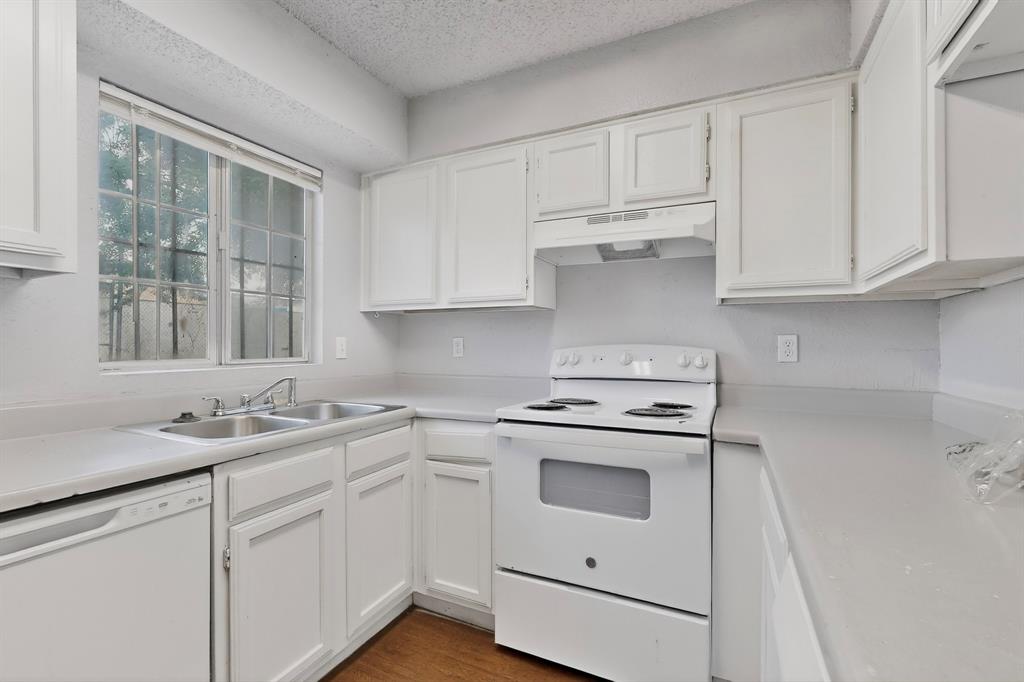 9467 Olde Towne Row Dallas, TX 75227 - Photo 8 of 26 a kitchen with white cabinets and white appliances