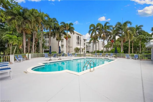 a swimming pool with outdoor seating and yard