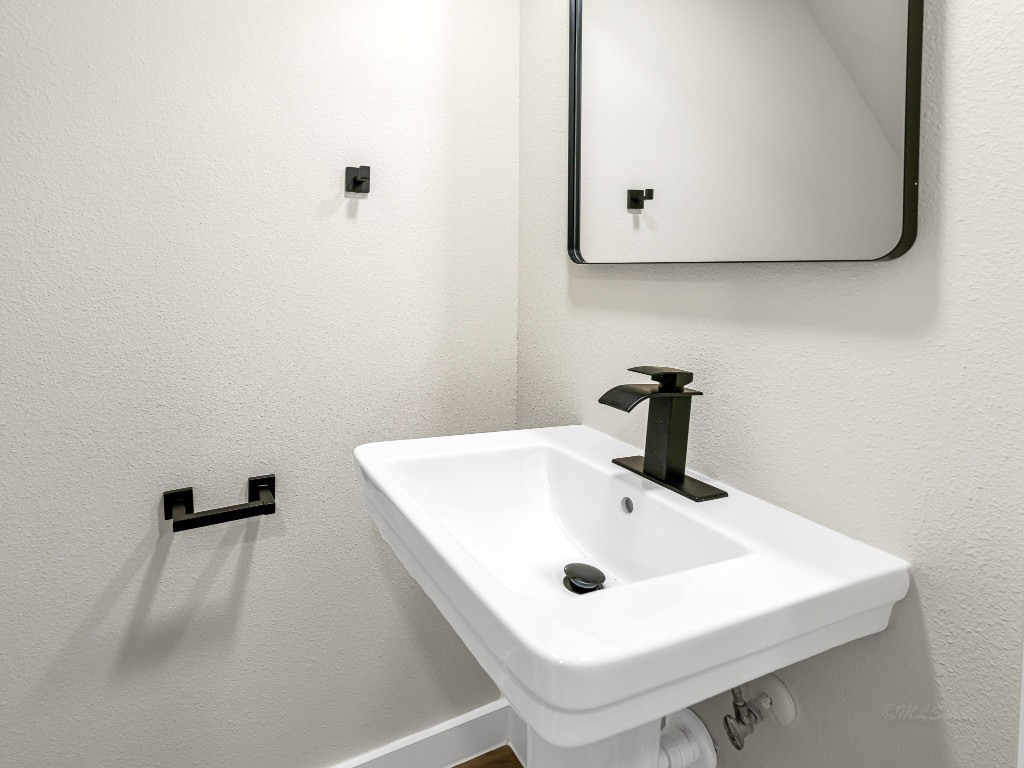 1006 4th Street Hempstead, TX 77445 - Photo 13 of 29 a bathroom with a sink and mirror