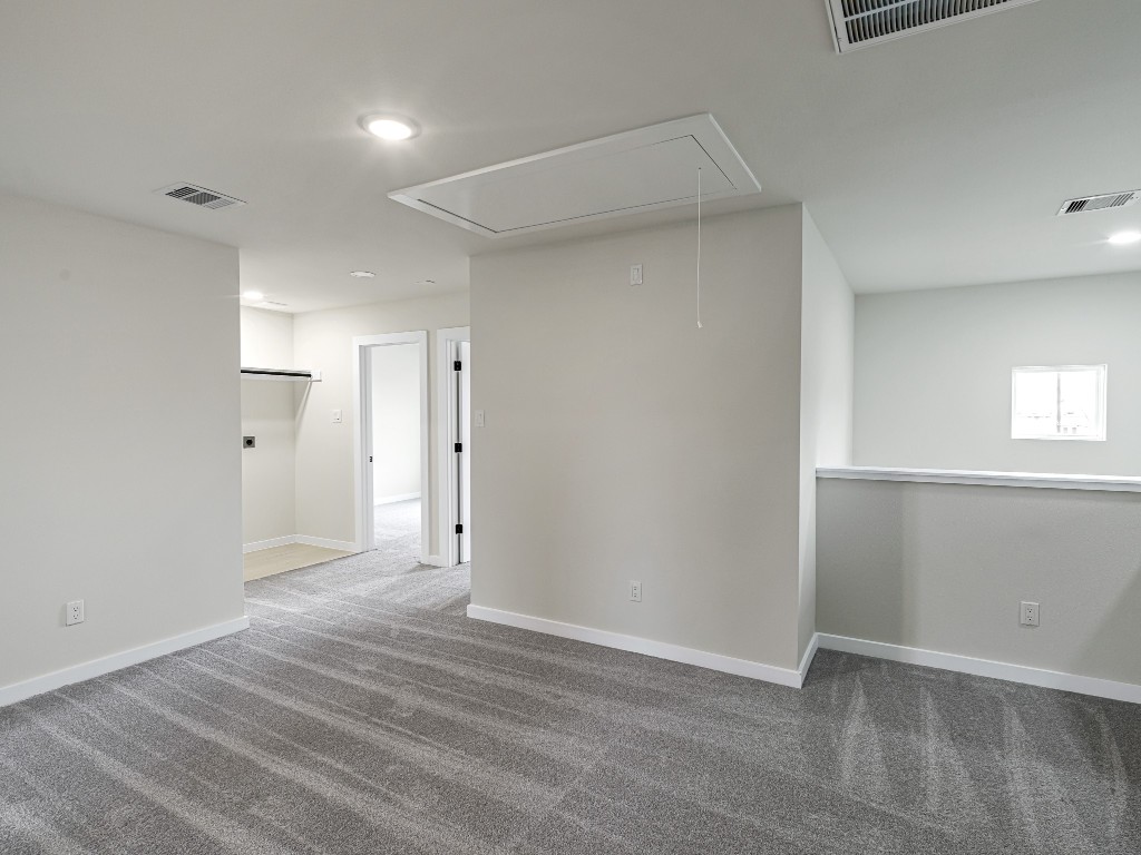 1006 4th Street Hempstead, TX 77445 - Photo 14 of 29 an empty room with wooden floor and windows