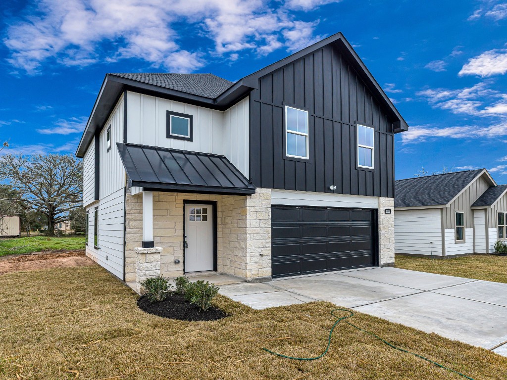 1006 4th Street Hempstead, TX 77445 - Photo 2 of 29 a front view of a house with a yard and garage