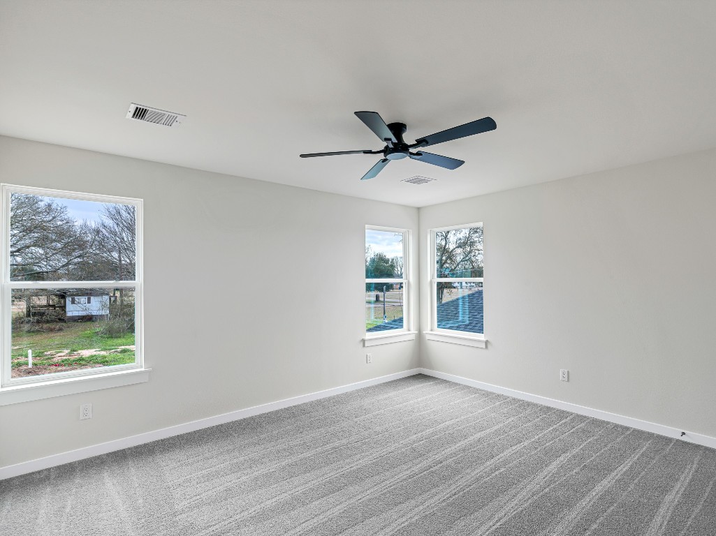 1006 4th Street Hempstead, TX 77445 - Photo 21 of 29 a view of an empty room with a window and a ceiling fan
