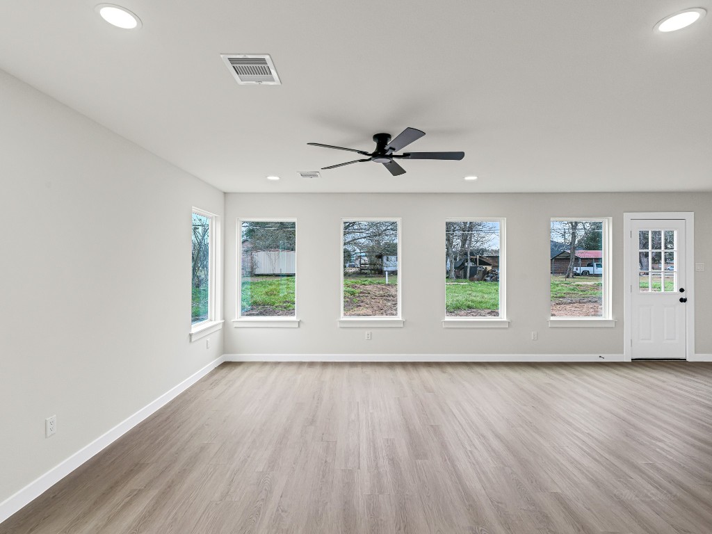 1006 4th Street Hempstead, TX 77445 - Photo 6 of 29 a view of room with wooden floor and windows