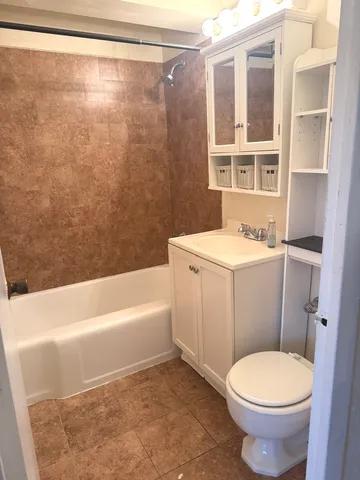 a bathroom with a sink a toilet and a bathtub