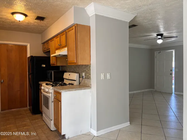 a kitchen that has a stove and a microwave