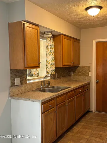 a kitchen with stainless steel appliances granite countertop a sink and a cabinets
