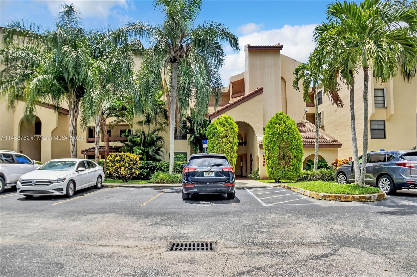 9140 Southwest 123rd Court, Unit 210Q Miami, FL 33186 - Photo 1 of 26 a car parked in front of a house