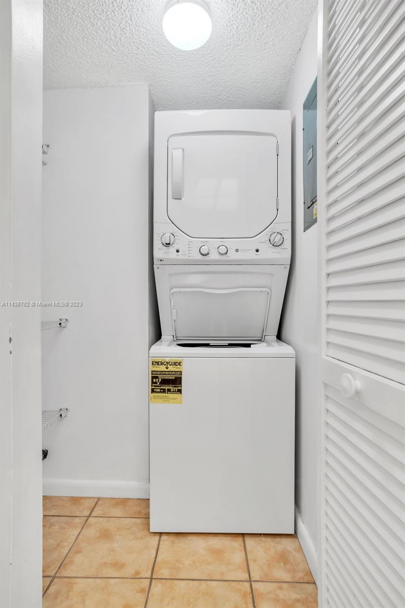 9140 Southwest 123rd Court, Unit 210Q Miami, FL 33186 - Photo 12 of 26 a utility room with dryer and washer