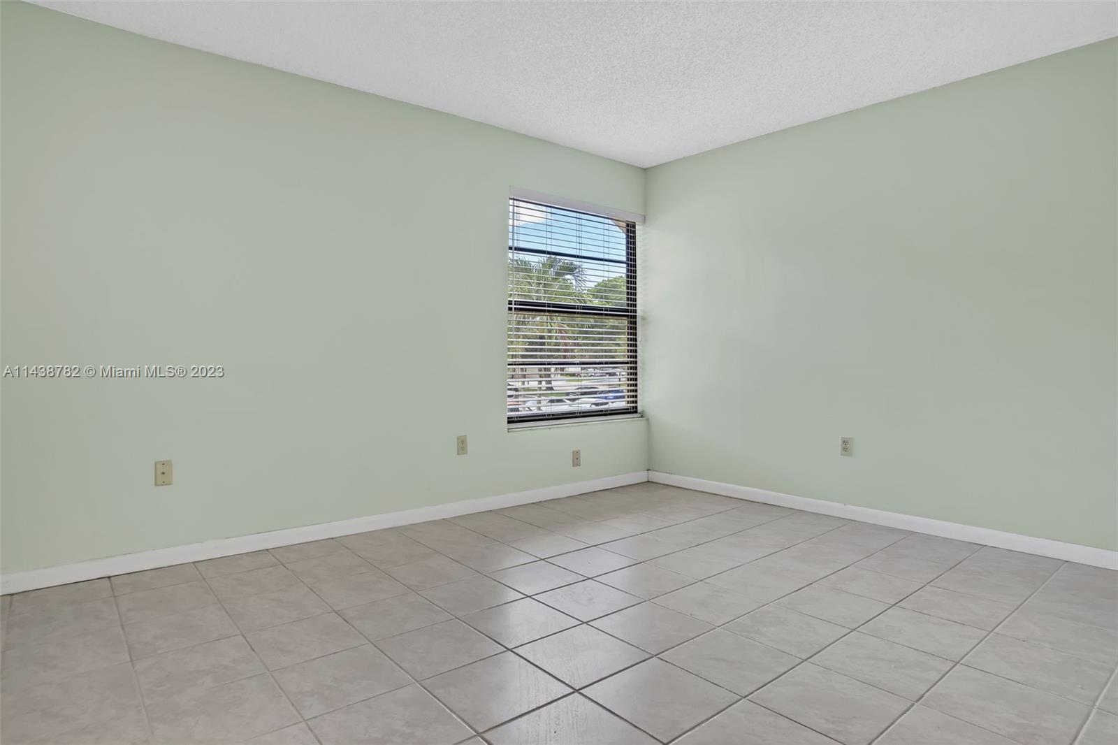 9140 Southwest 123rd Court, Unit 210Q Miami, FL 33186 - Photo 13 of 26 a view of an empty room with a window