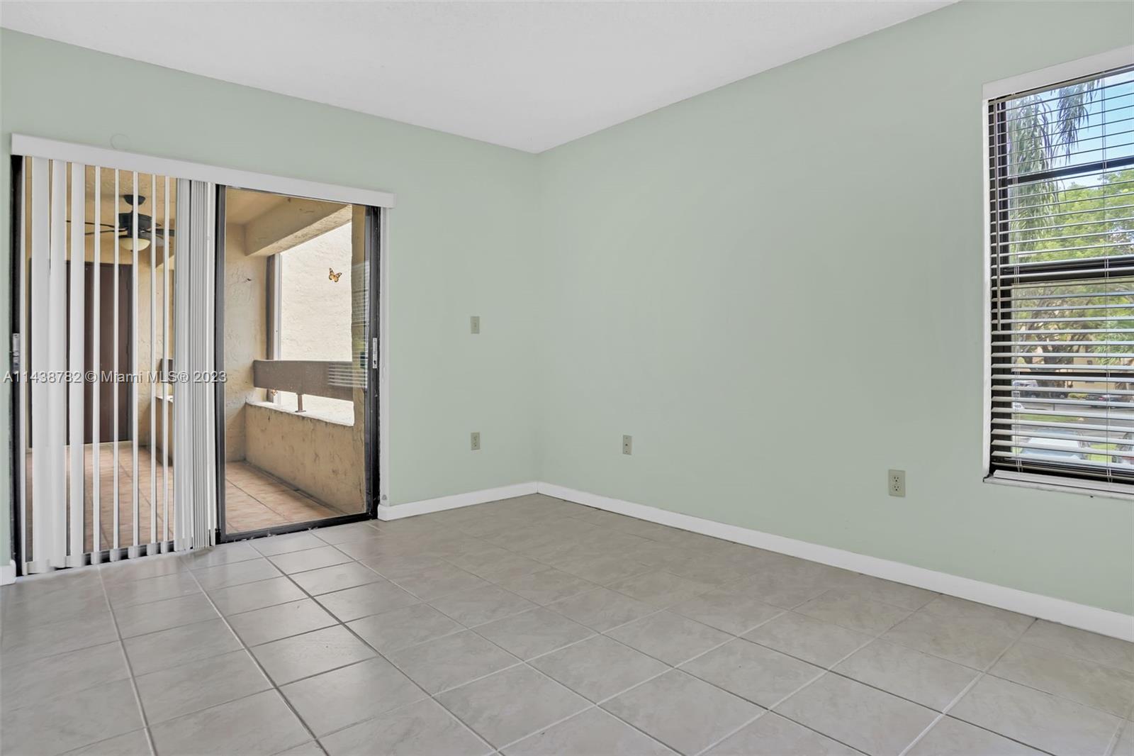 9140 Southwest 123rd Court, Unit 210Q Miami, FL 33186 - Photo 14 of 26 an empty room with windows