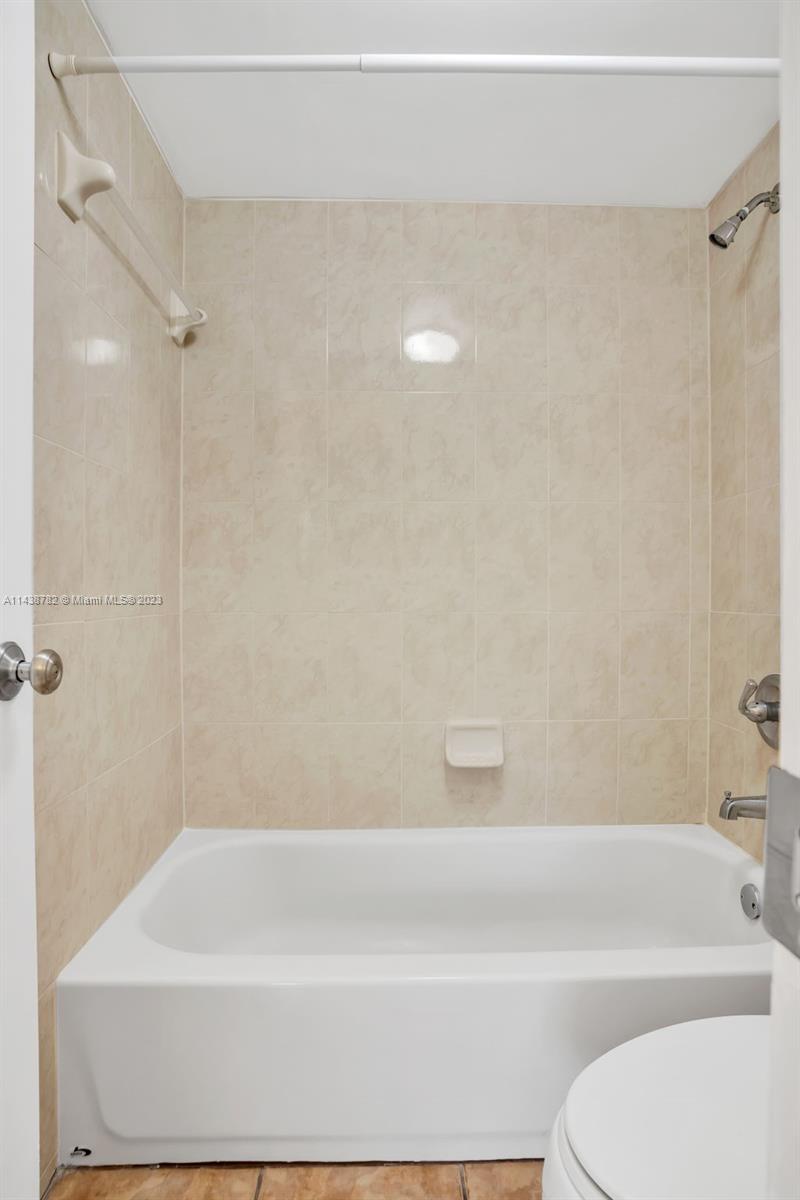 9140 Southwest 123rd Court, Unit 210Q Miami, FL 33186 - Photo 17 of 26 a bathroom with a bathtub and shower