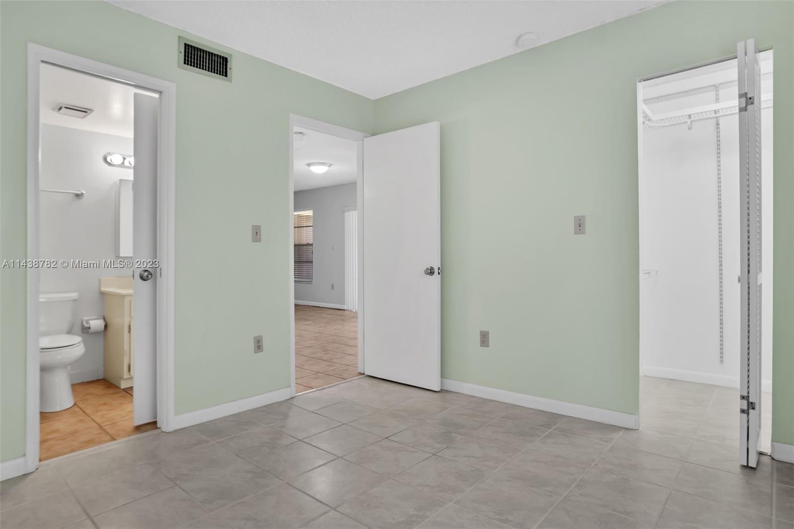 9140 Southwest 123rd Court, Unit 210Q Miami, FL 33186 - Photo 20 of 26 a view of a bathroom with a shower and a toilet