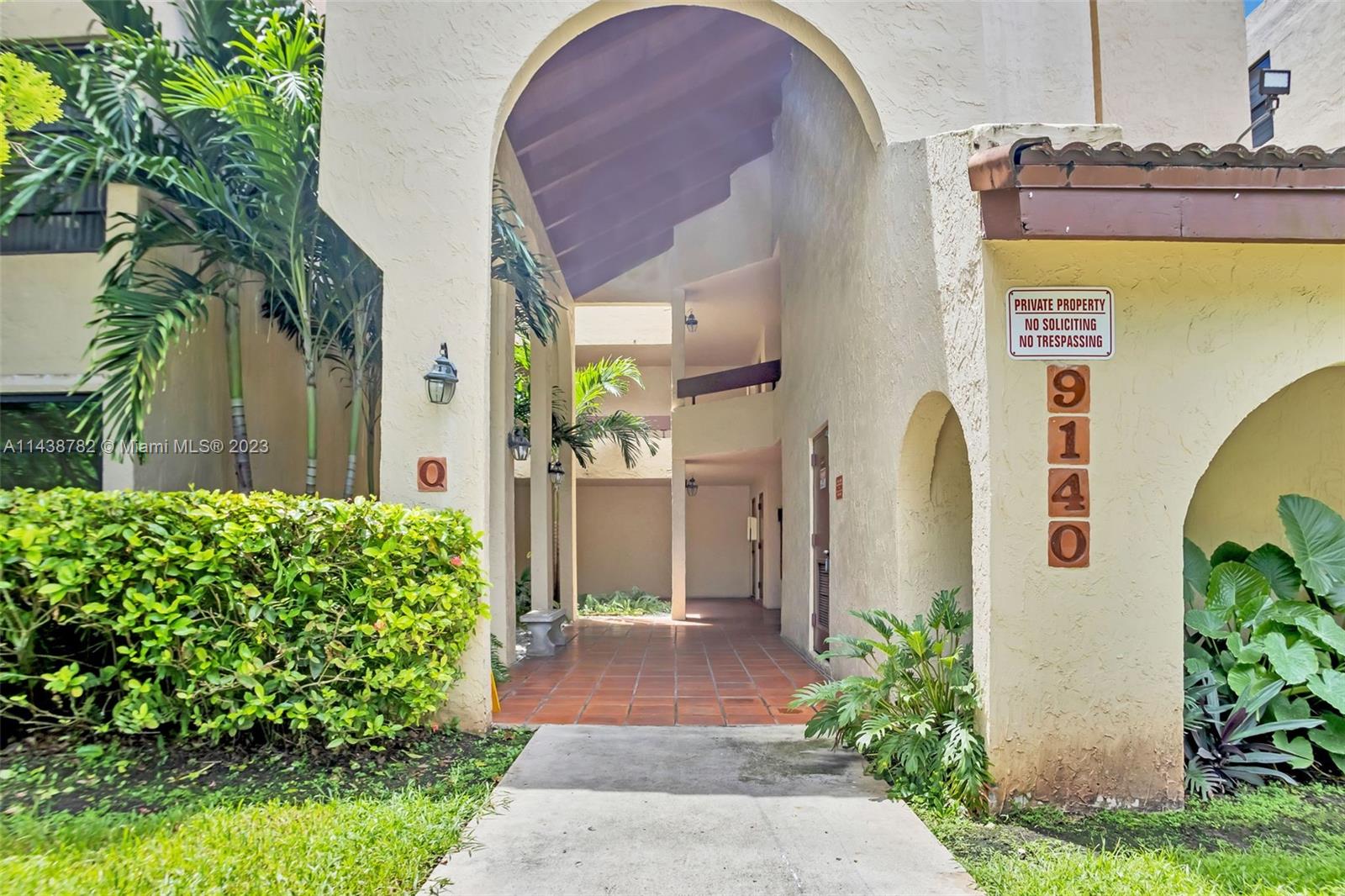 9140 Southwest 123rd Court, Unit 210Q Miami, FL 33186 - Photo 2 of 26 a front view of a house with a yard