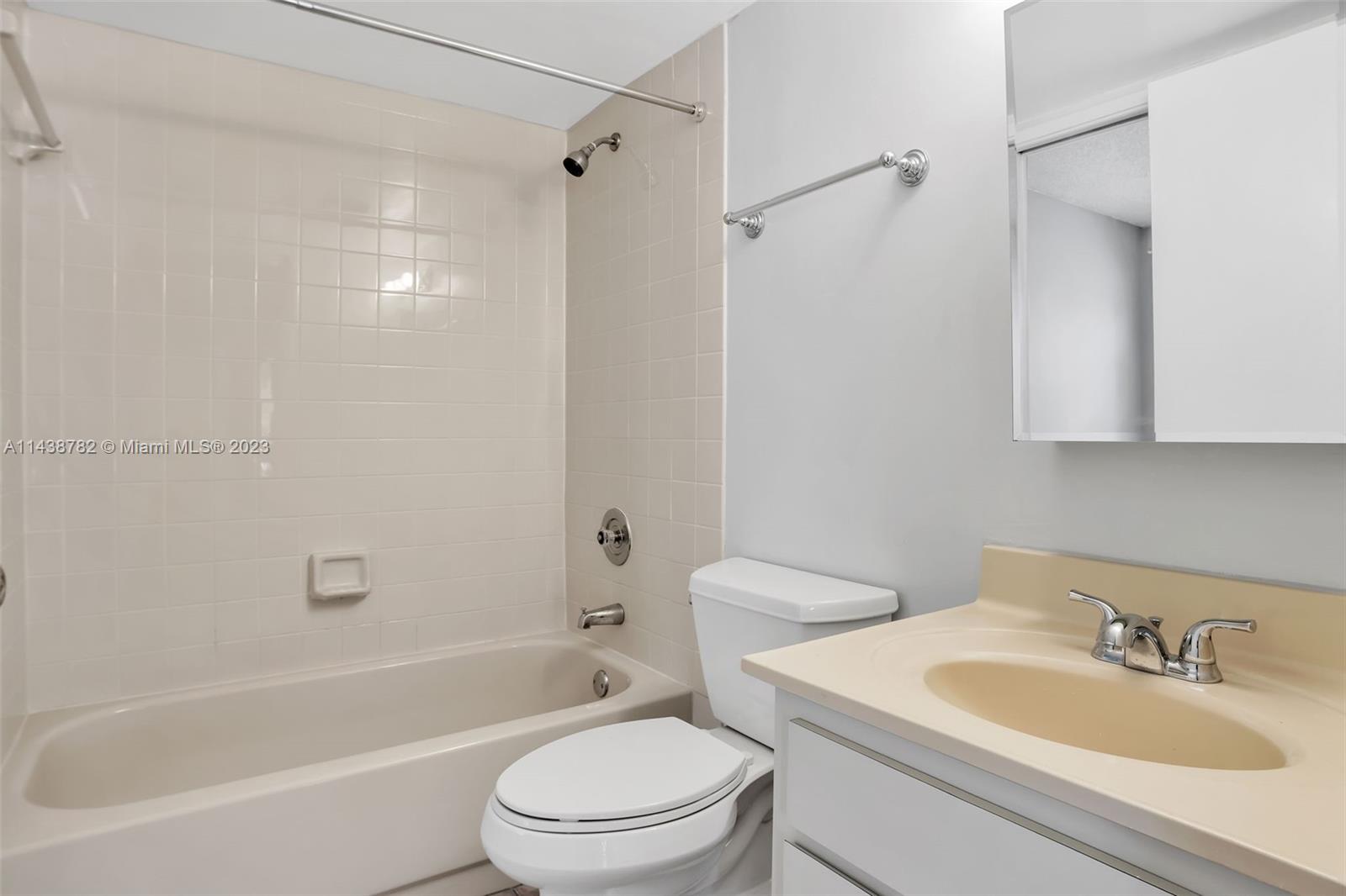 9140 Southwest 123rd Court, Unit 210Q Miami, FL 33186 - Photo 21 of 26 a bathroom with a sink toilet and shower