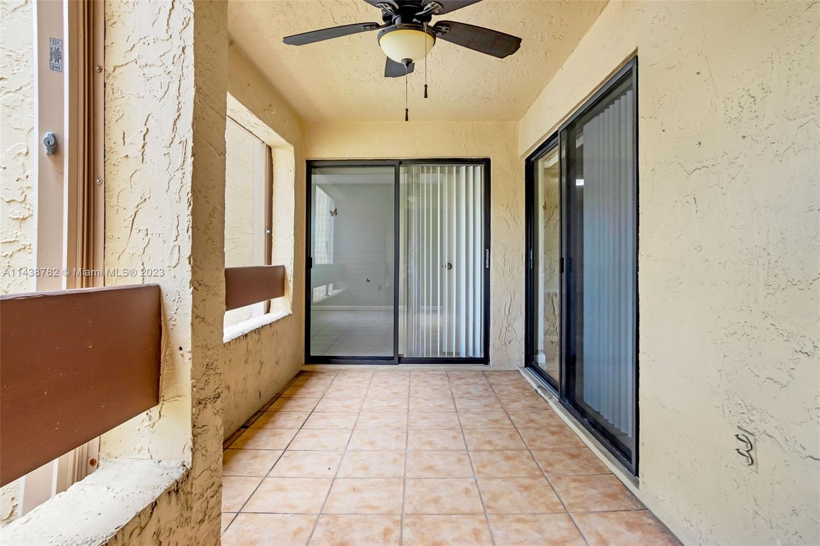 9140 Southwest 123rd Court, Unit 210Q Miami, FL 33186 - Photo 22 of 26 a view of a hallway with windows