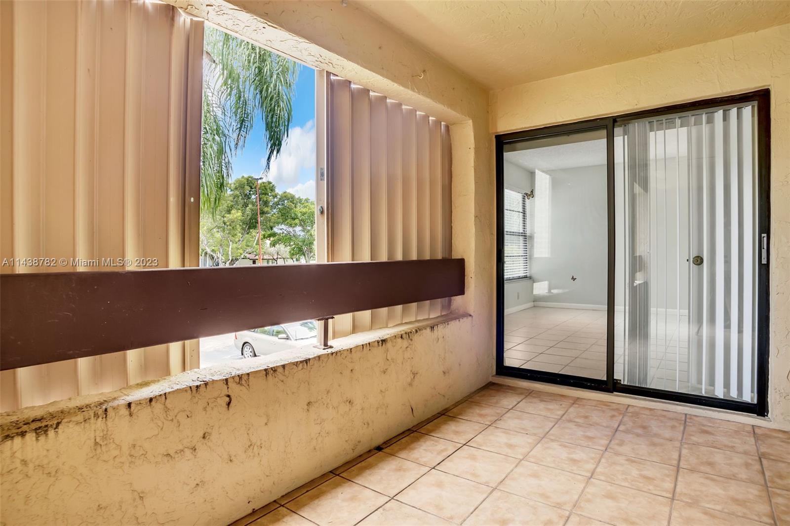 9140 Southwest 123rd Court, Unit 210Q Miami, FL 33186 - Photo 25 of 26 a view of a large window with an outdoor space
