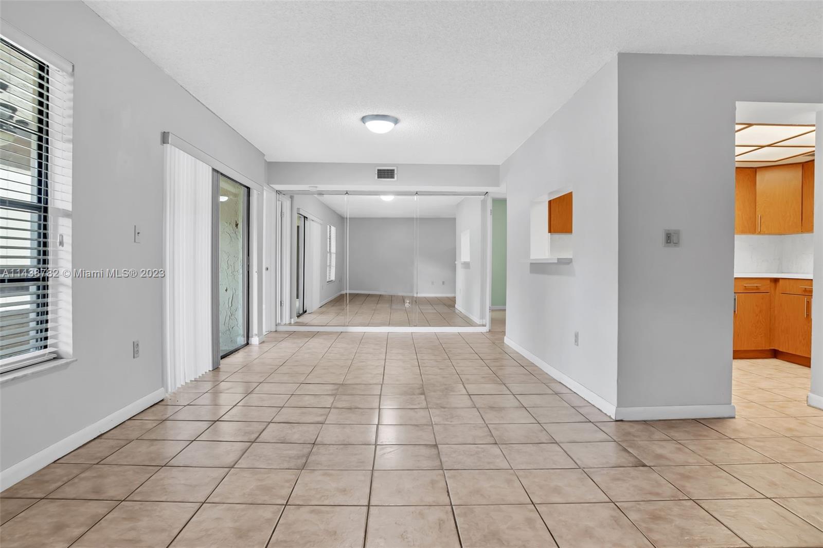 9140 Southwest 123rd Court, Unit 210Q Miami, FL 33186 - Photo 4 of 26 a view of a hallway to an empty room and window