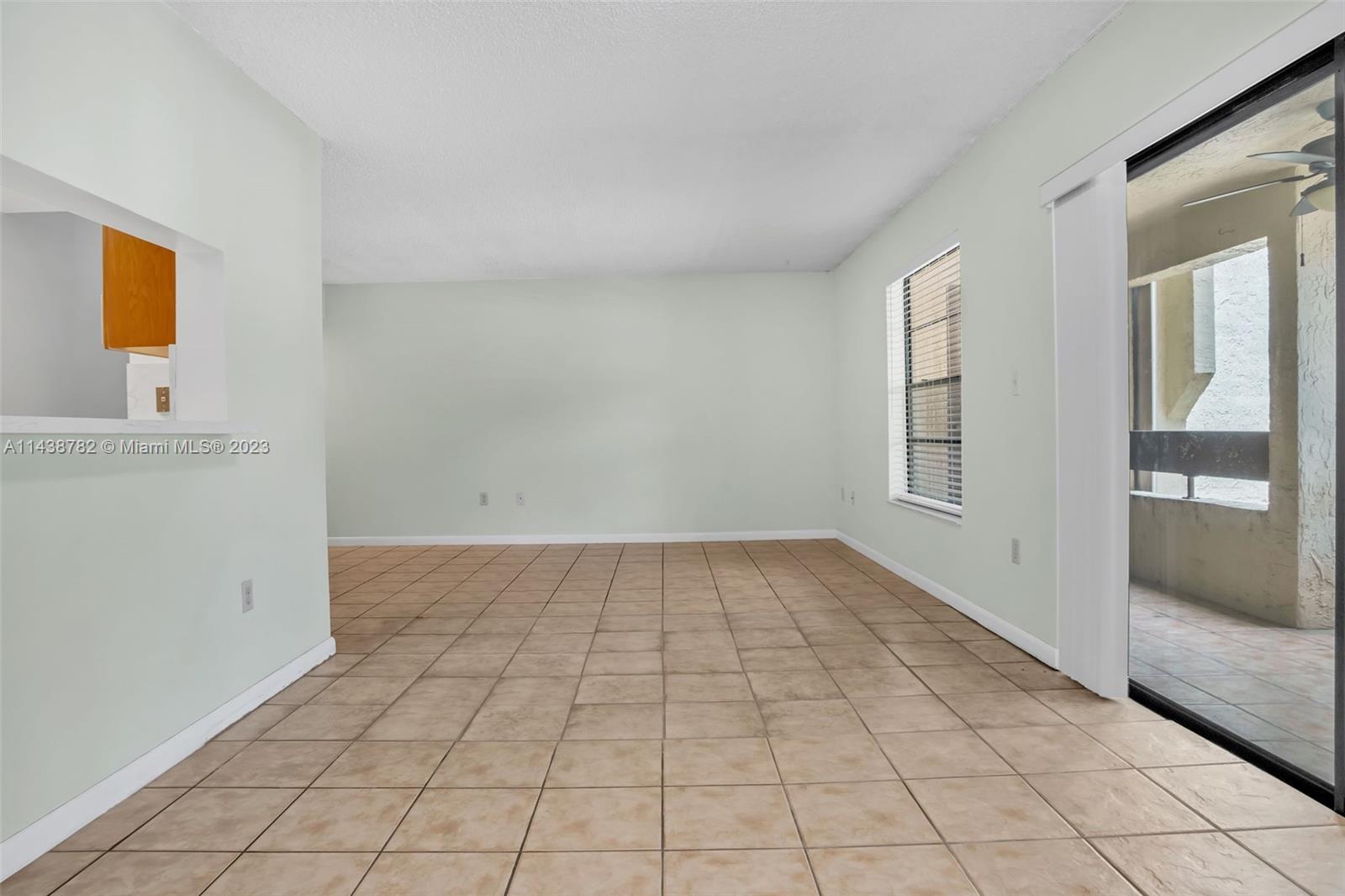9140 Southwest 123rd Court, Unit 210Q Miami, FL 33186 - Photo 5 of 26 an empty room with windows