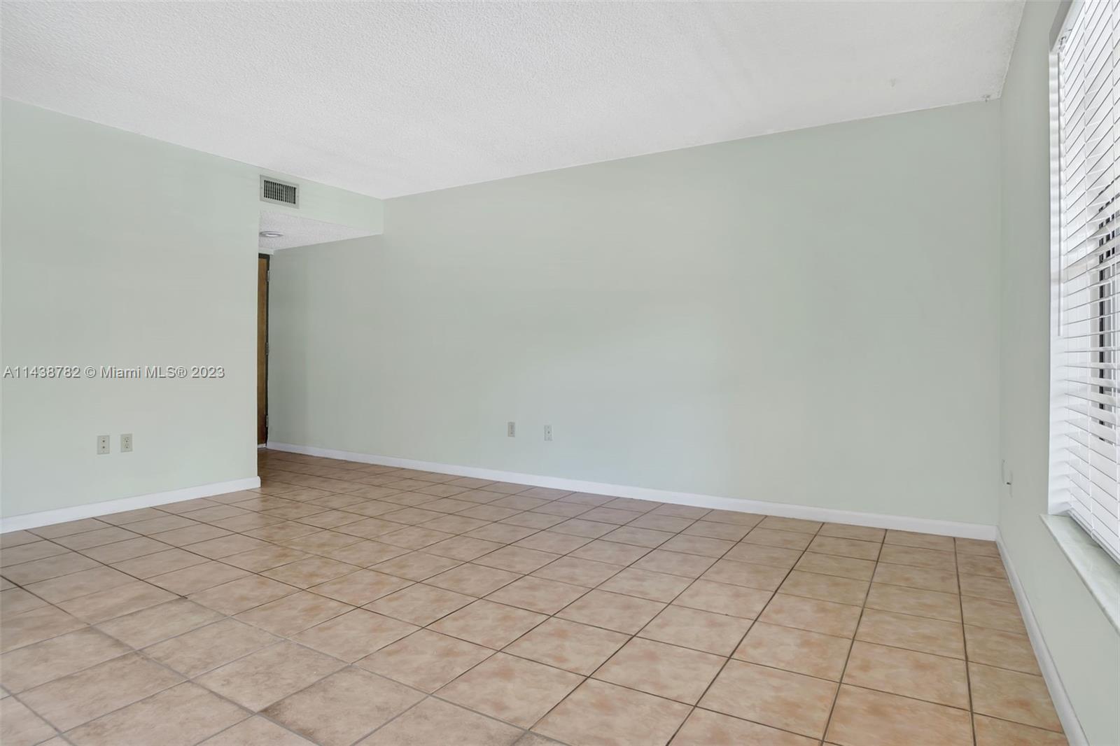 9140 Southwest 123rd Court, Unit 210Q Miami, FL 33186 - Photo 6 of 26 an empty room with white walls and tiles