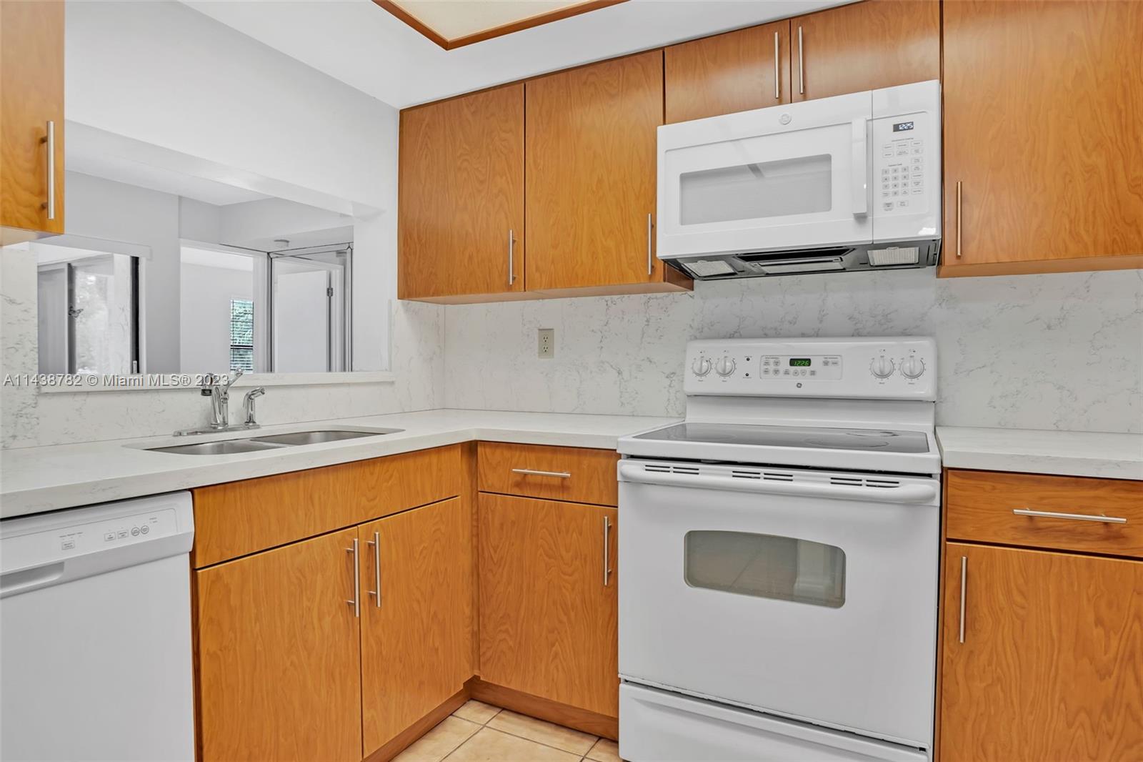 9140 Southwest 123rd Court, Unit 210Q Miami, FL 33186 - Photo 10 of 26 a utility room with sink dryer and washer
