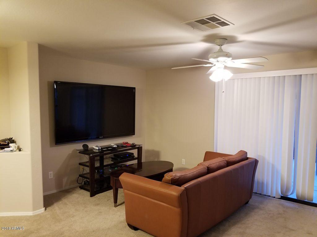 2721 South Powell Road Apache Junction, AZ 85119 - Photo 13 of 25 a living room with furniture and a flat screen tv