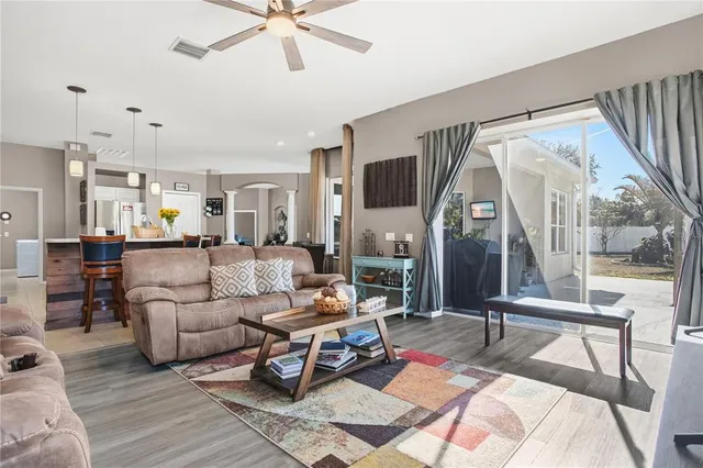 a living room with furniture a rug and a chandelier