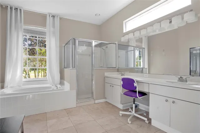 a bathroom with a bath tub mirror and sink