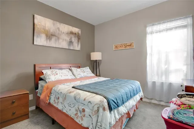 a bedroom with bed and a window