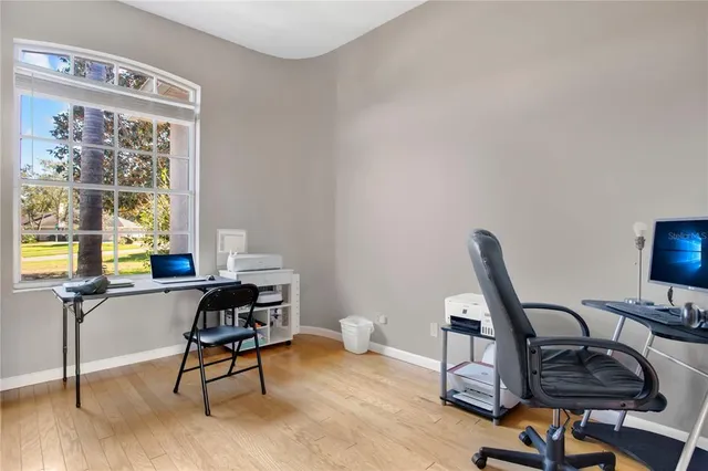 a view of a workspace with furniture and a window