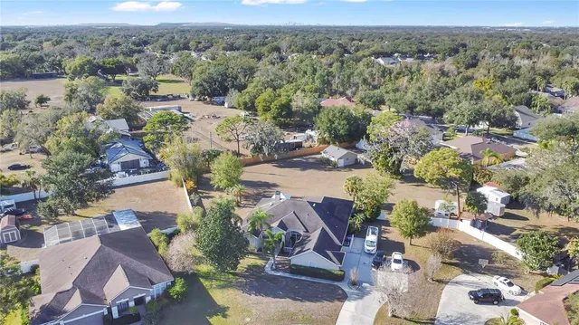 an aerial view of a residential houses with outdoor space
