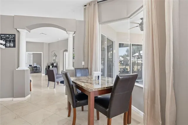 a view of a dining room with furniture and chandelier