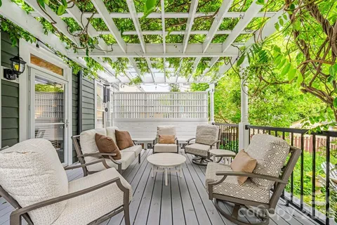 a view of a patio with couches and wooden floor