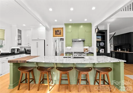 a kitchen with stainless steel appliances granite countertop a stove and a refrigerator