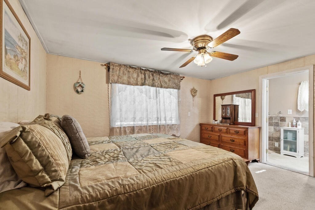 306 Andover Road Billerica, MA 01821 - Photo 16 of 42 a bedroom with a bed and a chandelier