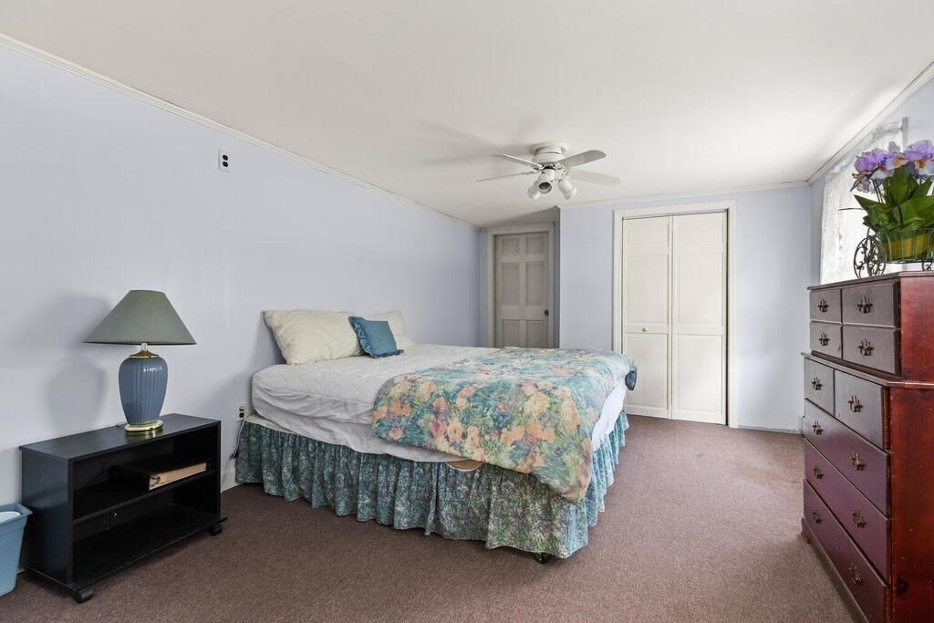 306 Andover Road Billerica, MA 01821 - Photo 21 of 42 a bedroom with a bed and a chandelier