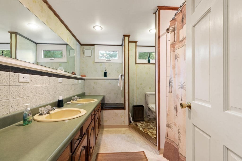 306 Andover Road Billerica, MA 01821 - Photo 25 of 42 a bathroom with a sink a mirror and a shower