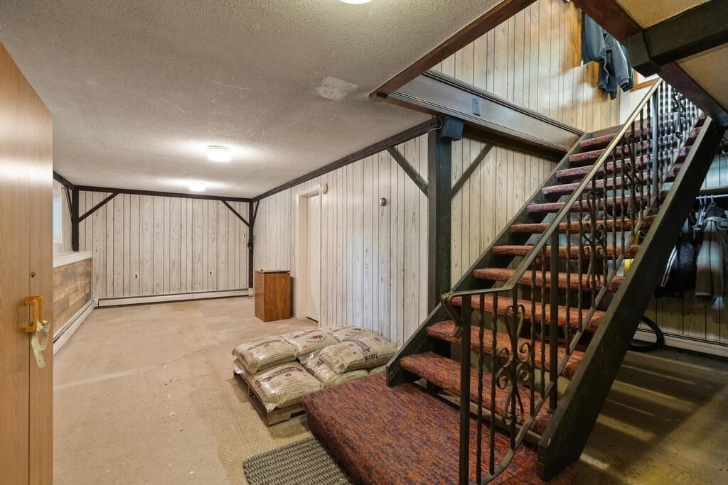 306 Andover Road Billerica, MA 01821 - Photo 28 of 42 a view of an empty room with wooden floor and stairs