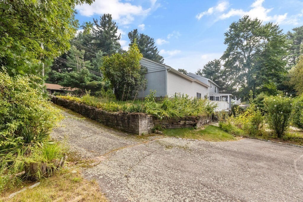 306 Andover Road Billerica, MA 01821 - Photo 33 of 42 a view of a backyard with plants and large trees