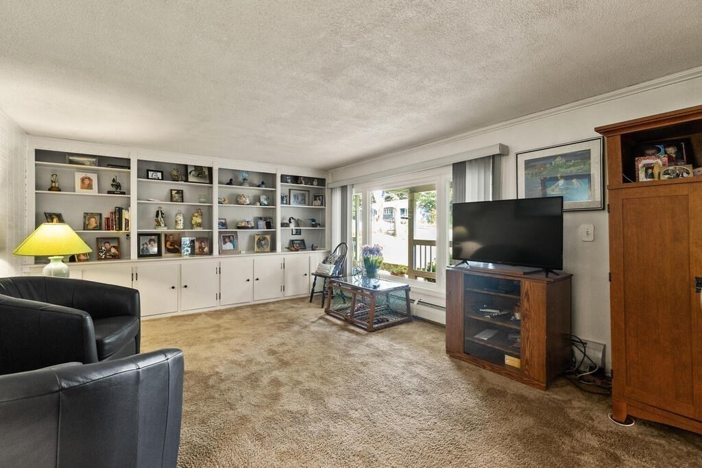 306 Andover Road Billerica, MA 01821 - Photo 7 of 42 a living room with furniture and a flat screen tv